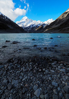 Crystal clear waters of Lake Pukaki and Mt Cook National Park in the background