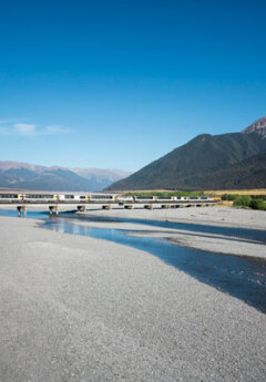 The TranzAlpine Crosses a river on a bridge