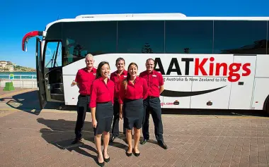 Coach tour crew and vehicle before New Zealand tour