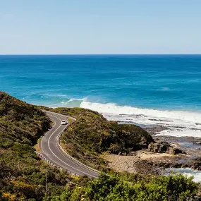 A car driving down the great ocean road in Wongara, Australia