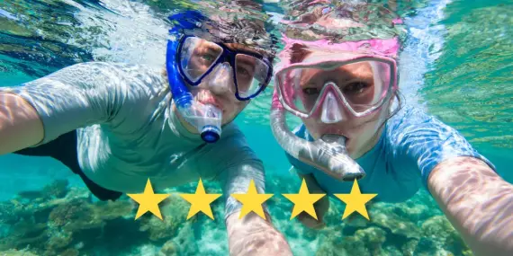 Under water photo of couple snorkelling in the ocean