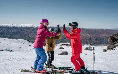 Ski Instructor celebrating with clients at Cardrona