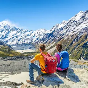 Tourists to New Zealand exploring view of mountains in a national park