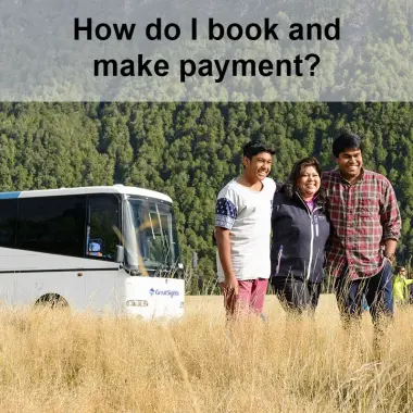 Family taking a photograph next to a tour coach in New Zealand