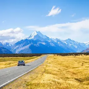 Photo been taken out of car window with mountains in South Island