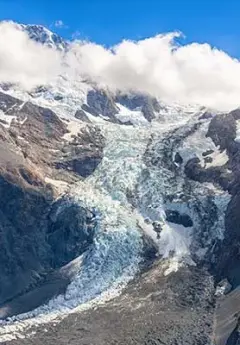 View of Fox Glacier partly covered by a white cloud