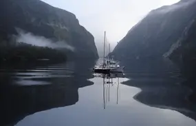 Fiordland Navigator sailing through Doubtful Sound on a moody grey day