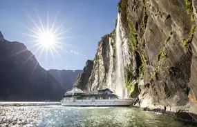 Milford Sound Cruise near a waterfall in the Sound