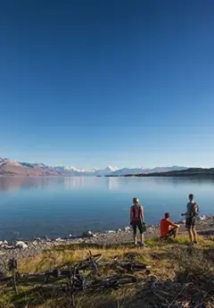 A group of travelers admiring Mount Cook over Lake Pukaki