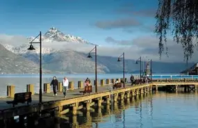 Queenstown wharf at sunrise with mist over the mountains