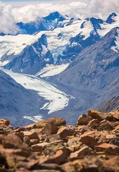 View of Franz Josef Glacier and white clouds in the back