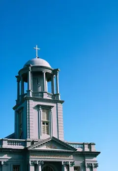 An old church with a bright blue sky in Hokitika