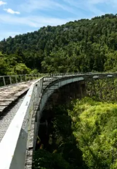 Railway with greenery surrounding and hills