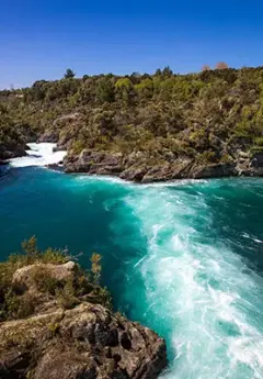 The turbulent water as it flows through the Huka Falls - A waterfall near Taupo