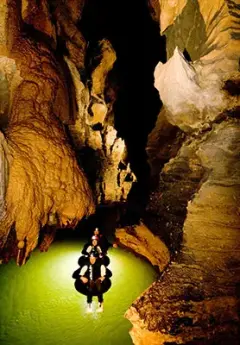 Group of travelers enjoying a tour in Waitomo Limestone Caves