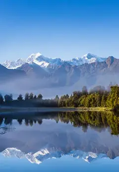 Glaciers, Mt Cook and  snow capped mountains reflected in Matheson Lake, West Coast