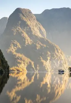 Cruising Doubtful Sound and reflections of mountains in the Sound