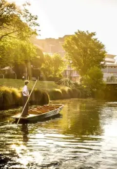 A man paddles a gondola boat down the Avon River in Christchurch