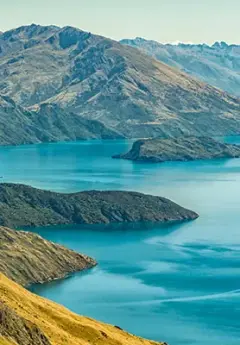 Aeriel view of a dark blue lake and mountain skirting the edges